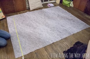 Lay out the rug underlay and the faux fur fabric and cut them to the same size. (In our case, 5×7 feet.)